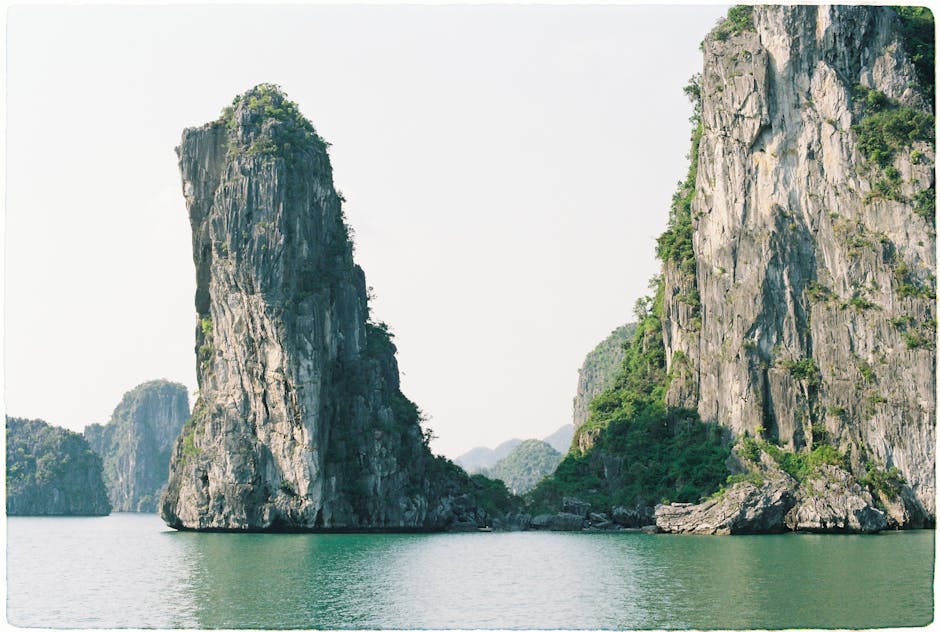 Scenic view of towering limestone islands in Ha Long Bay, Vietnam, under clear skies.