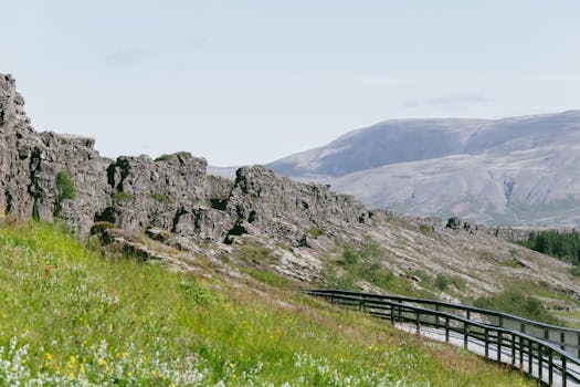 Stunning view of rocky cliffs and footpath at Þingvellir National Park, Iceland.