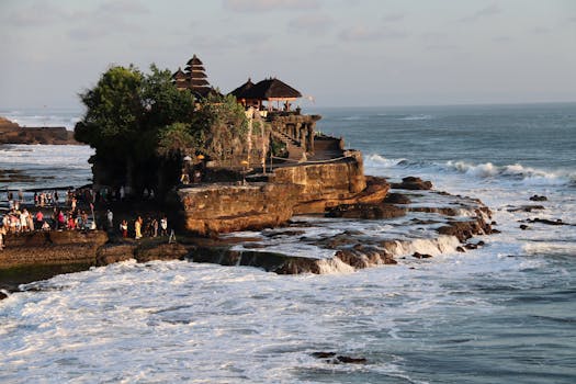 Breathtaking view of Tanah Lot Temple on the rocky coast of Bali, Indonesia, during sunset.