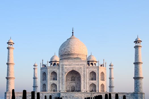 Explore the architectural beauty of the Taj Mahal at sunrise, a UNESCO heritage site in India.