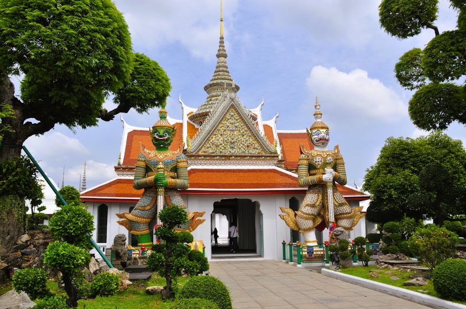 Vibrant giant demon statues at Wat Arun temple, Bangkok, Thailand.