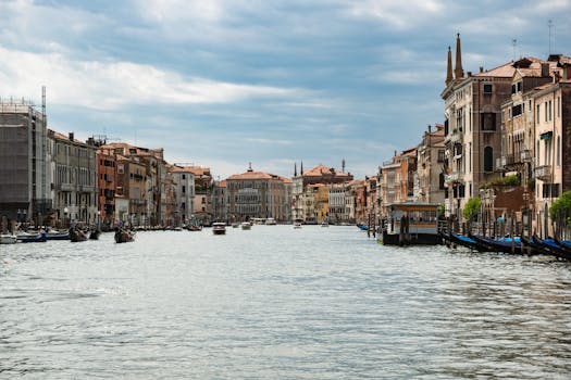 Scenic view of Venice's Grand Canal showcasing historic buildings and gondolas.