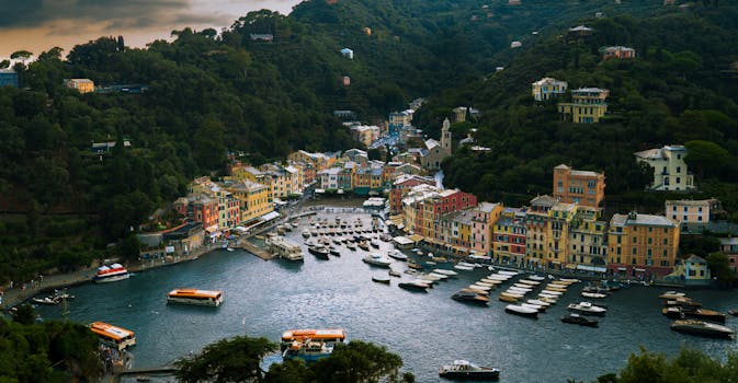 A vibrant view of Portofino harbor with colorful buildings and boats in Liguria, Italy.
