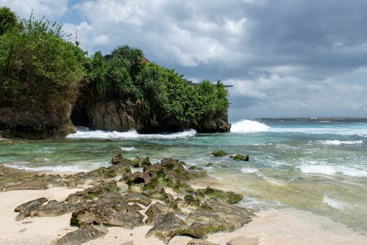 Explore the serene beauty of Padang Padang Beach in Bali featuring clear waters and lush greenery.