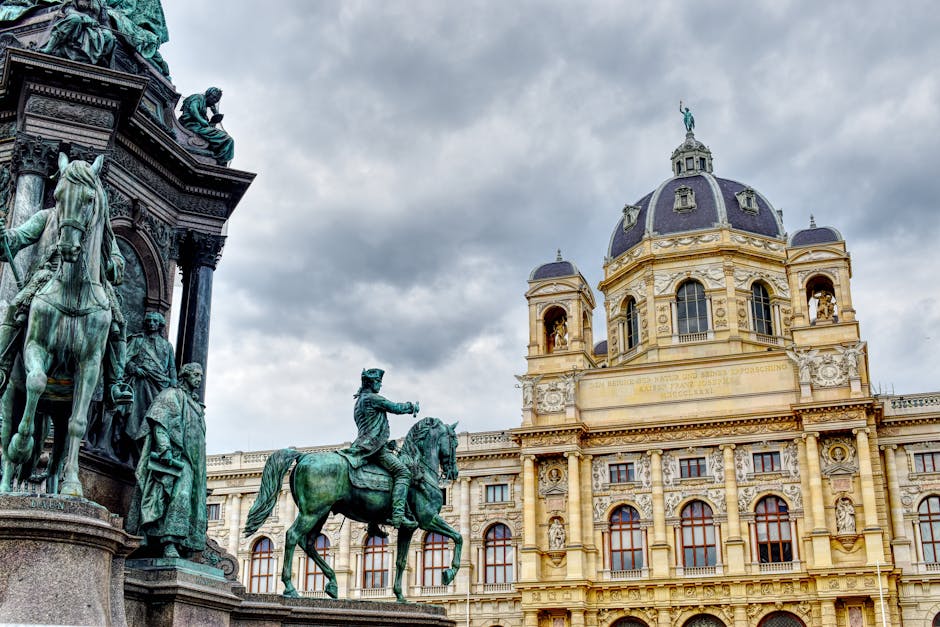 Magnificent view of Vienna's Kunsthistorisches Museum and the Maria Theresa monument under a cloudy sky.