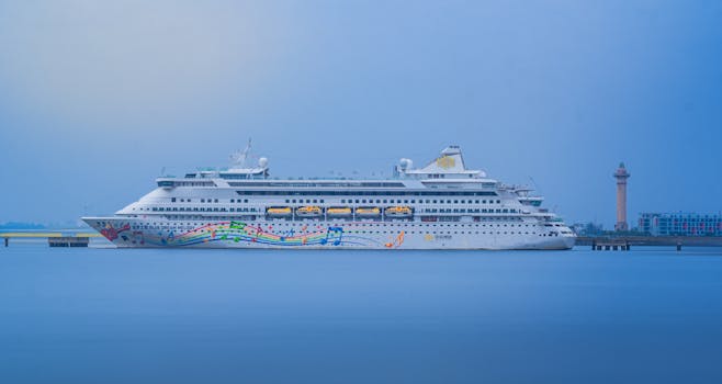 Colorful cruise ship docked in a Vietnam harbor, showcasing vibrant musical artwork.
