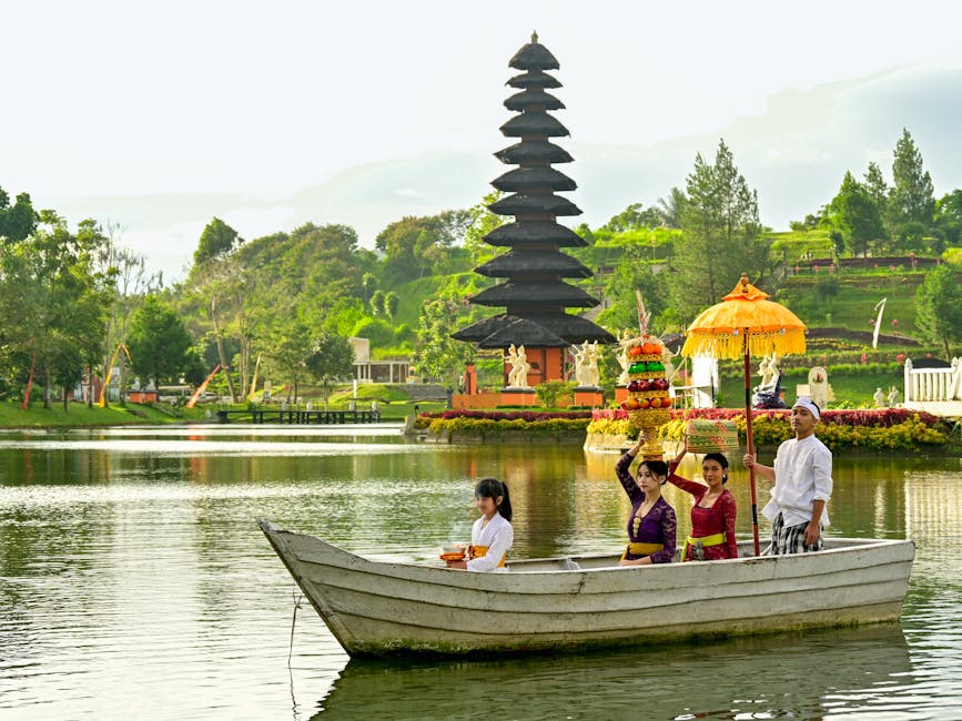 Traditional Balinese ceremony with locals on a boat near a temple in Indonesia.